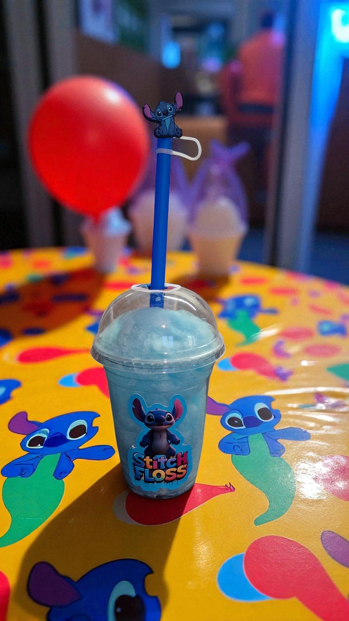 Frozen drink with a straw holder featuring a character on a colorful table.