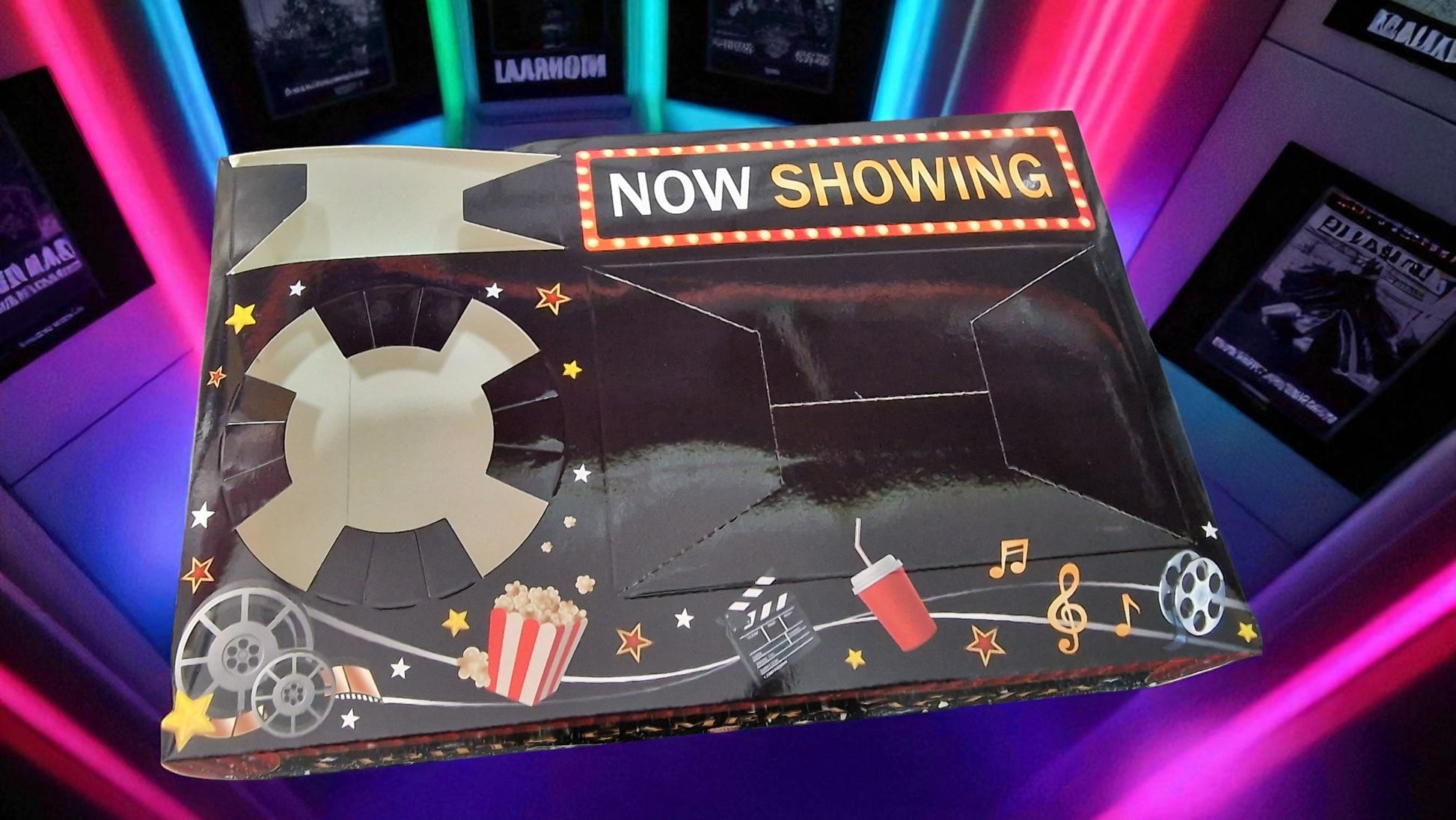 Decorative box with 'Now Showing' sign and movie-themed design on a colorful background