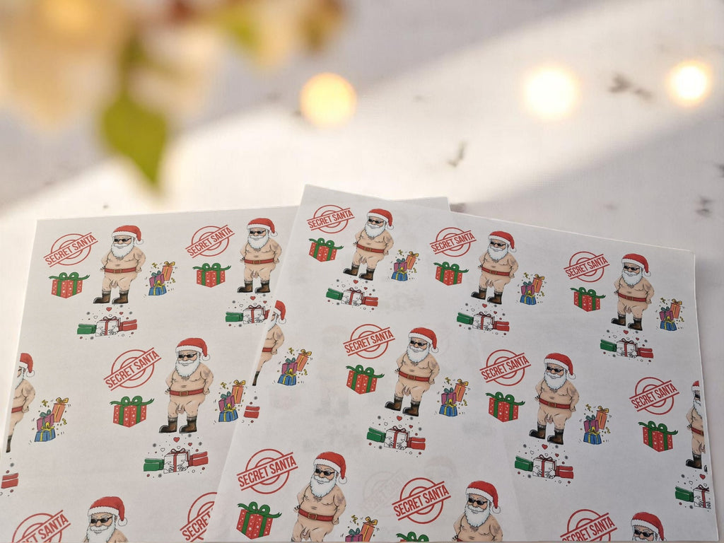 Cheeky Secret Santa Christmas wrapping paper featuring a cartoon naked Santa with gifts, Secret Santa stamps, and colourful presents on white A3 sheets