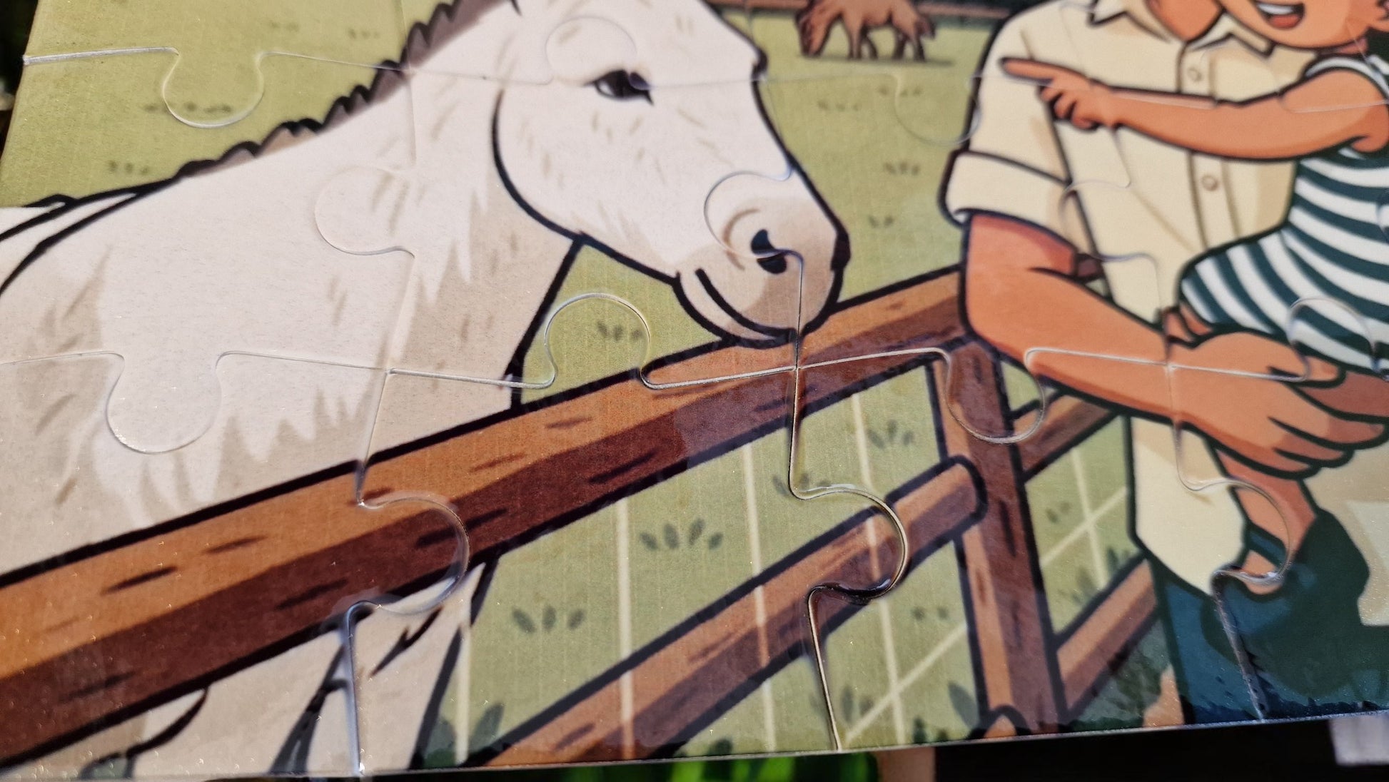 Partial view of a cartoon-style illustration with a horse and a person.