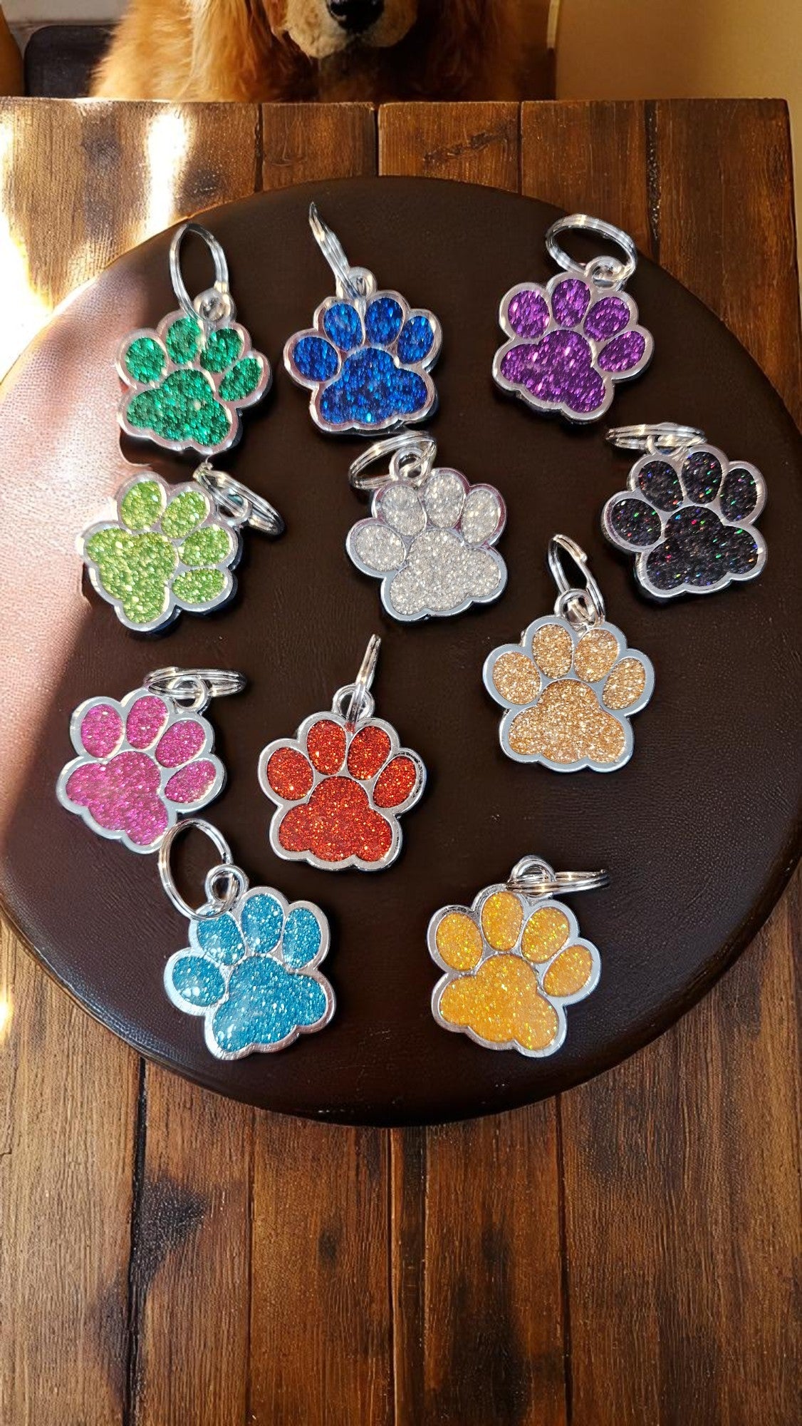 Colorful paw-shaped keychains on a dark surface