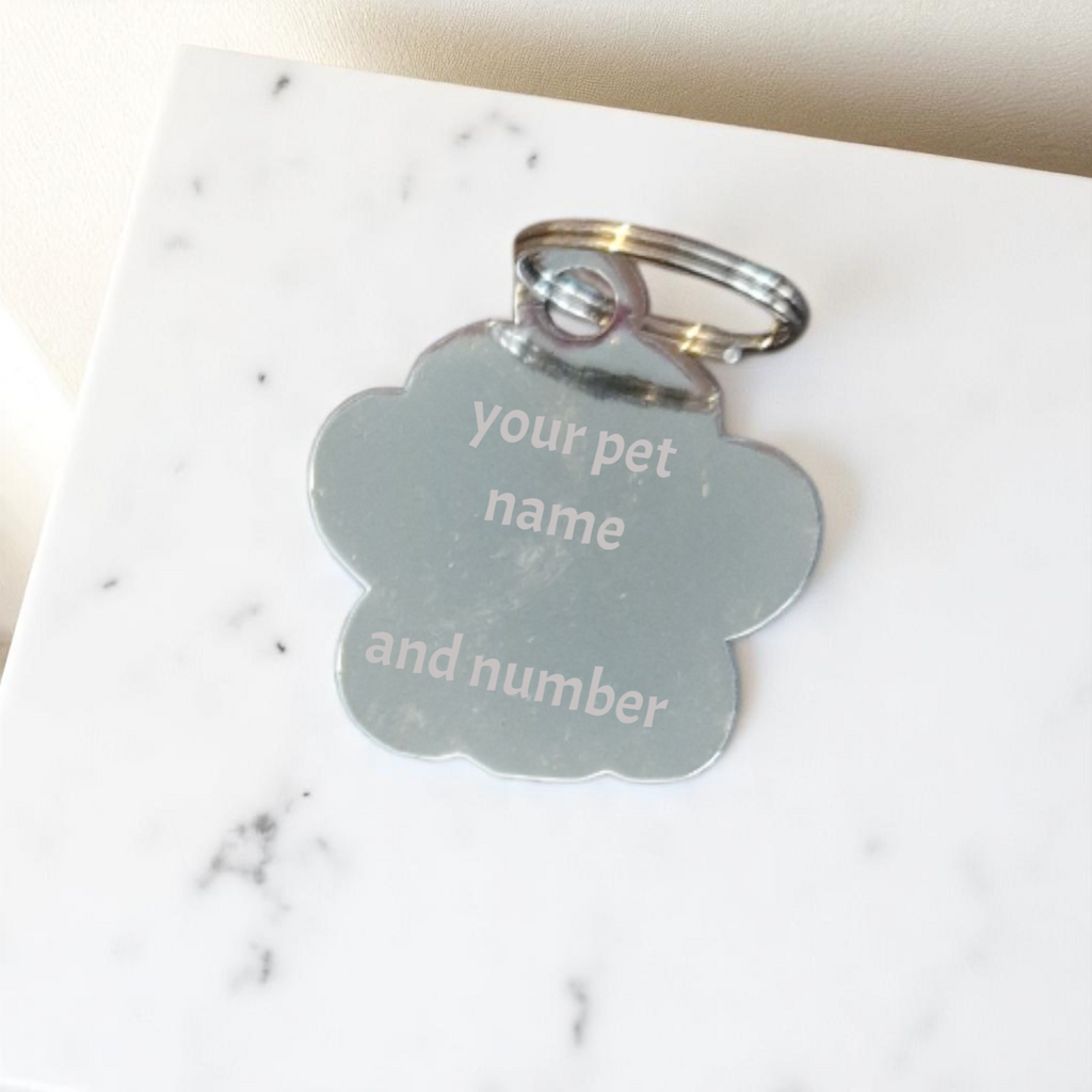 Pet tag with customizable text on a marble surface
