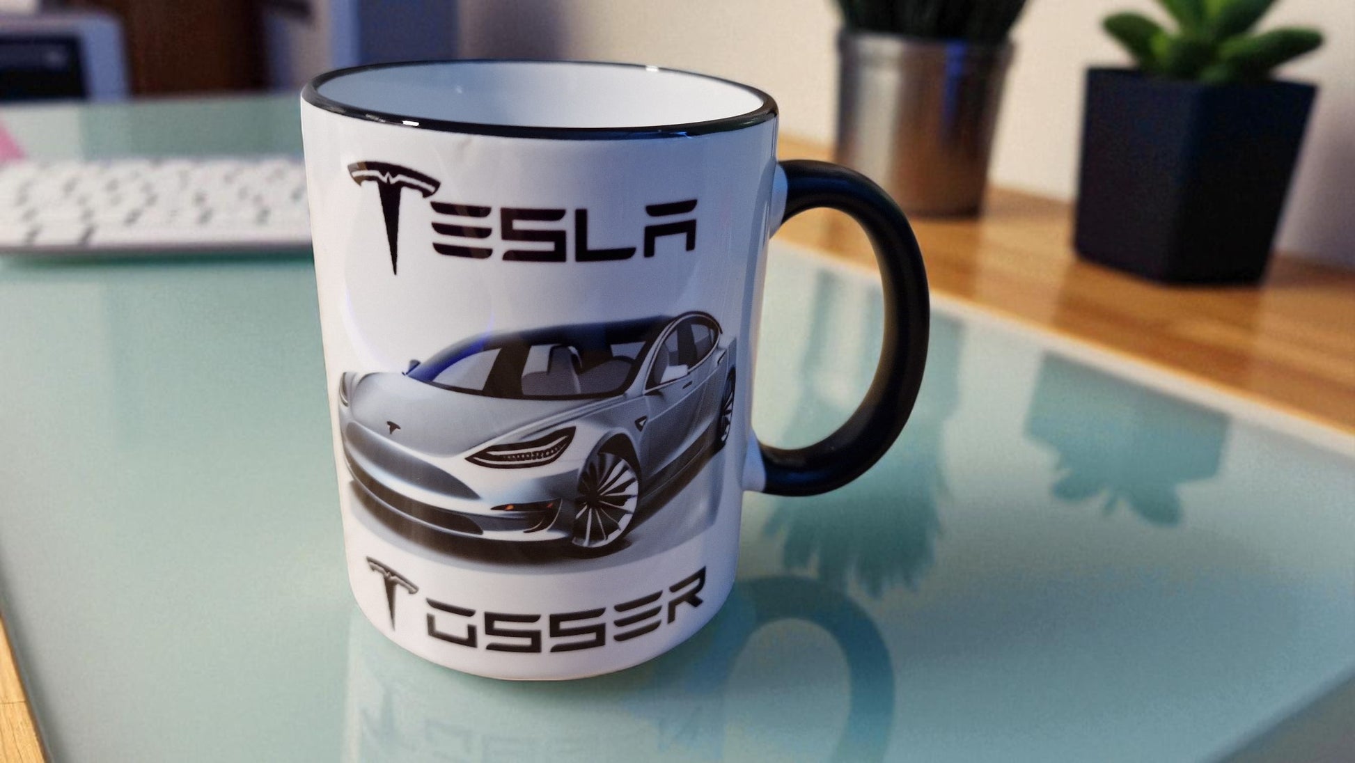 Tesla mug with car design on a glass table