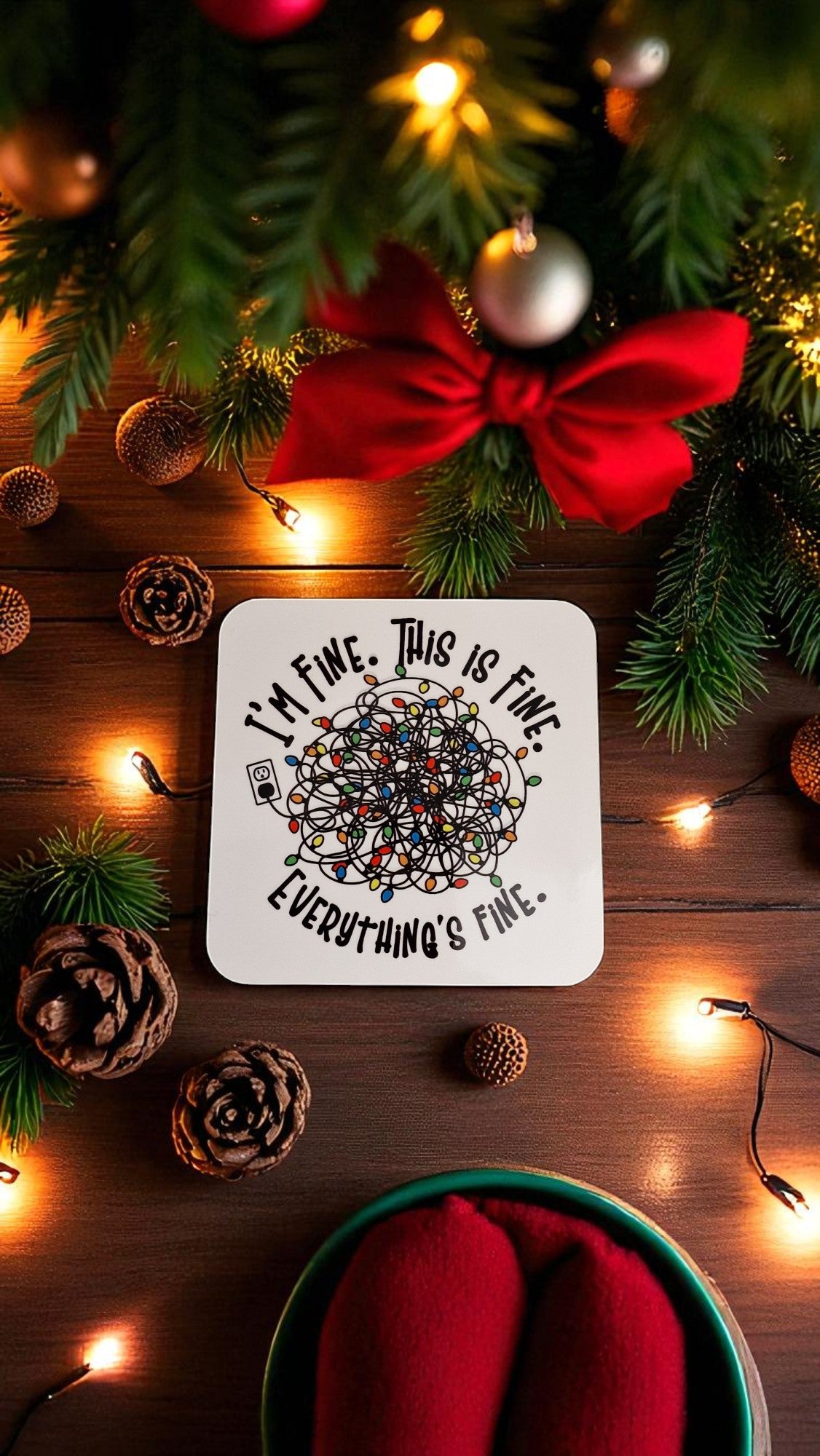 Coaster with text 'I'm fine, this is fine, everything is fine' on a Christmas-themed background with lights and decorations.