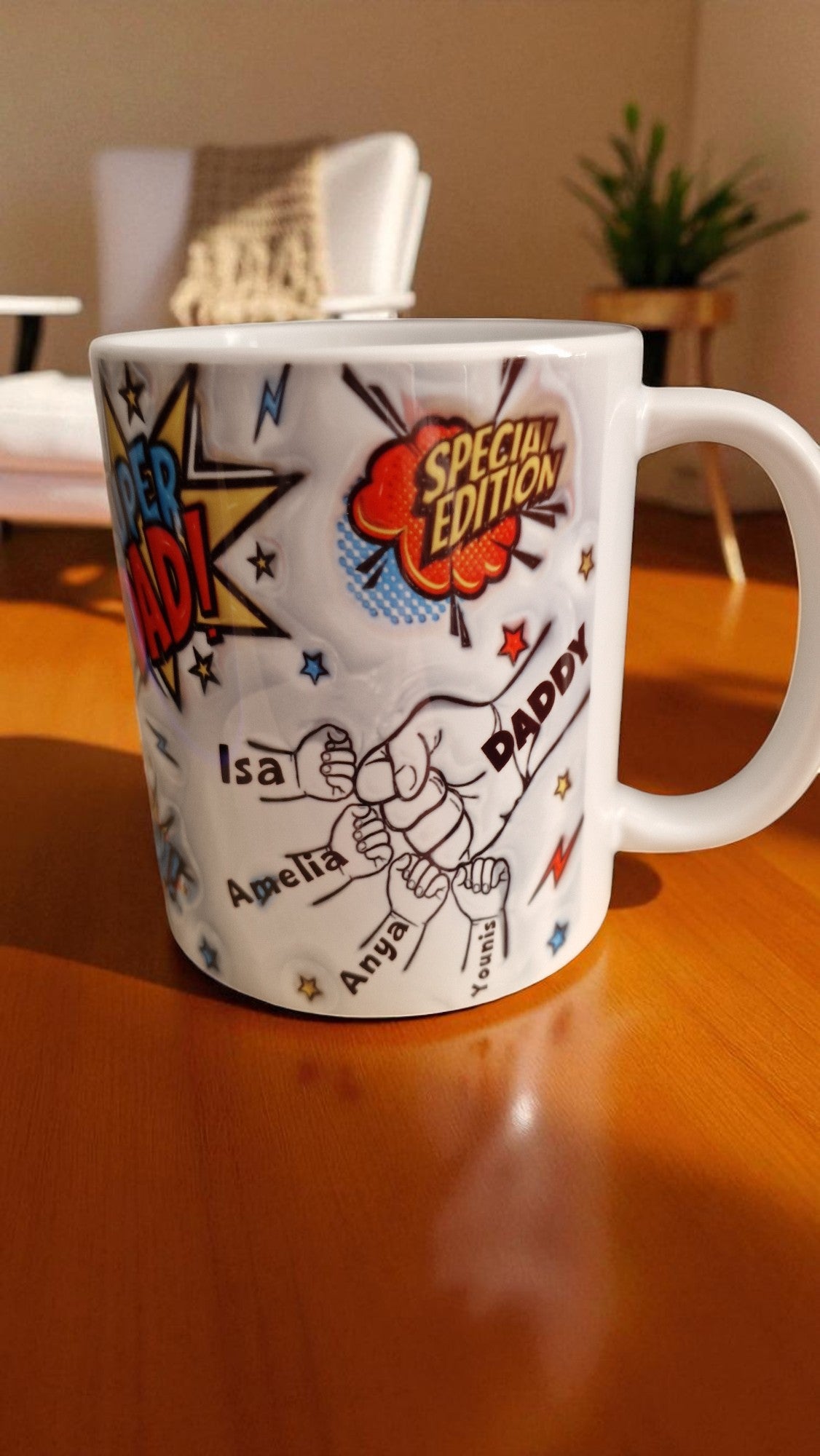 White mug with colorful graphics and text on a wooden surface