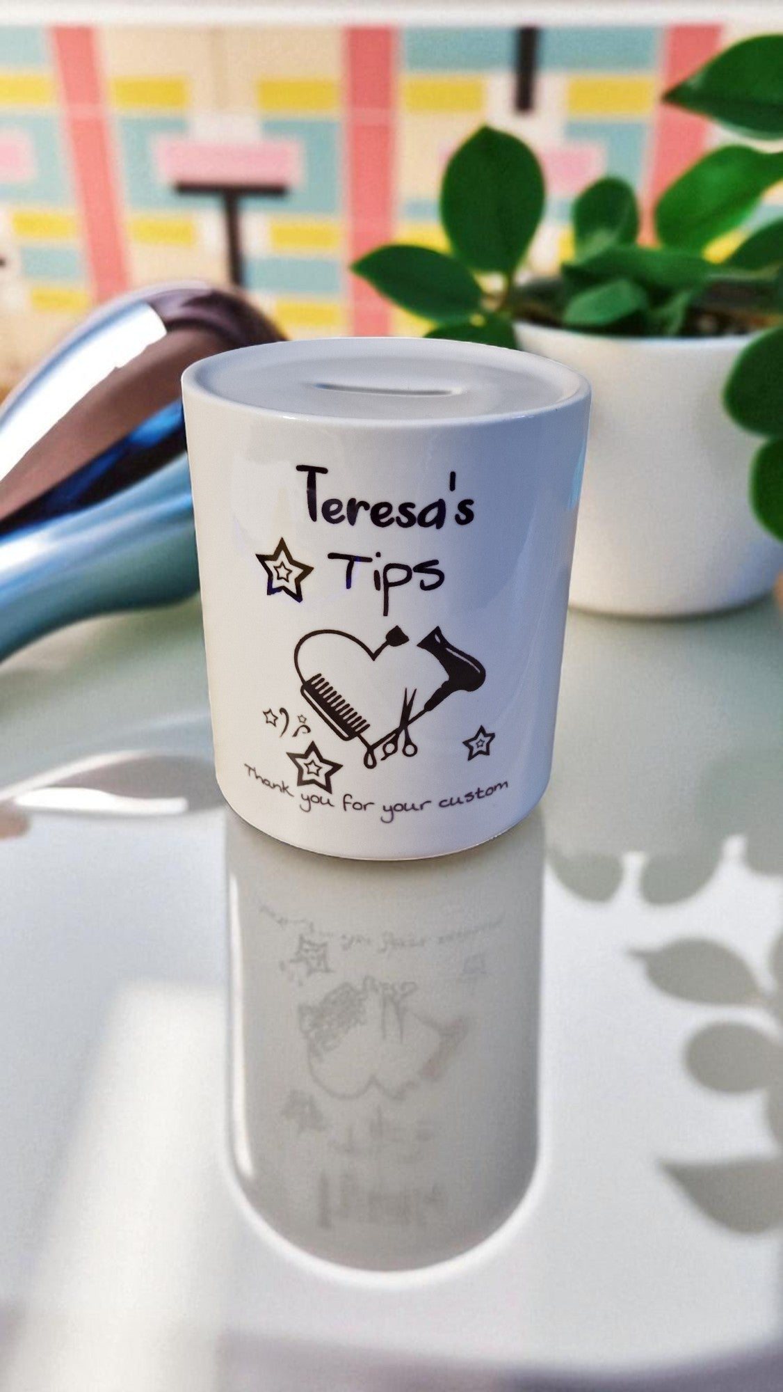 White container with 'Teresa's Tips' text on a reflective surface with a colorful background.