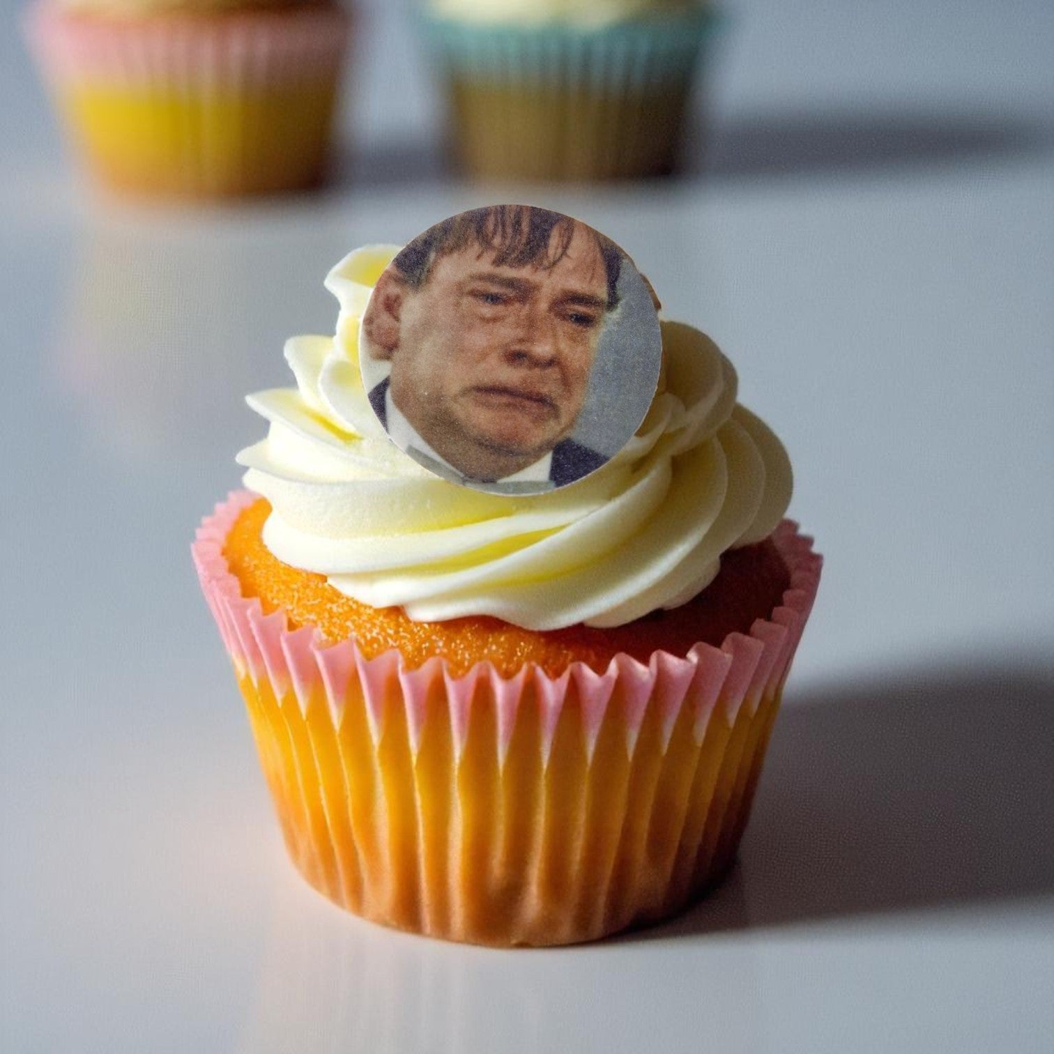 Set of 15 pre-cut edible cupcake toppers featuring Ian Beale meme faces from EastEnders, printed on wafer paper. Retro 80s, 90s, and 00s themed party decorations, suitable for vegans."