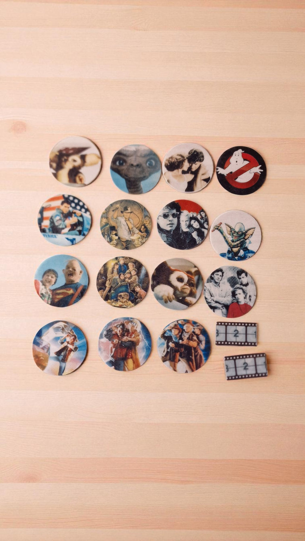 Collection of round stickers with various designs on a wooden surface