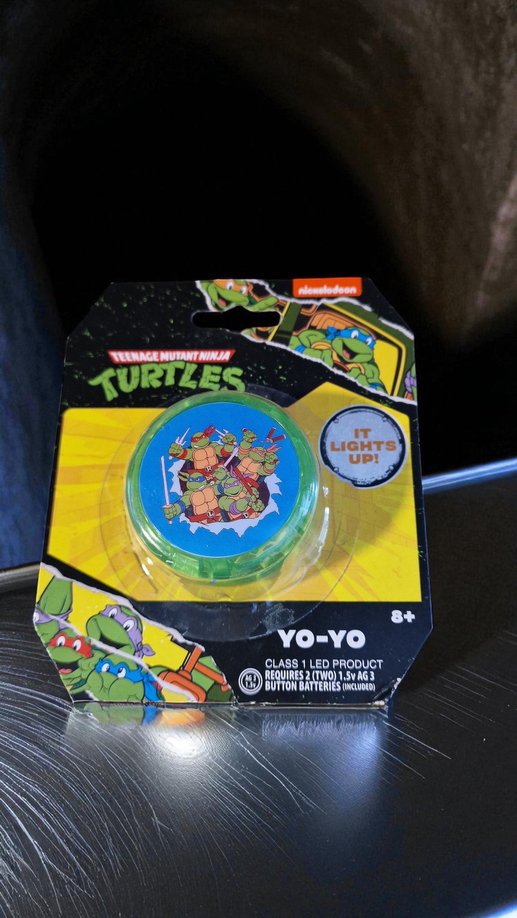 Green Nickelodeon Teenage Mutant Ninja Turtles light up yo-yo with all four TMNT characters on the front, glowing in the light.
