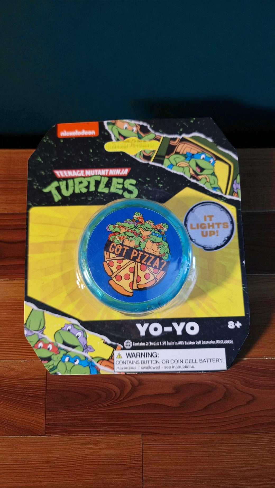 Green Nickelodeon Teenage Mutant Ninja Turtles light up yo-yo with all four TMNT characters on the front, glowing in the light.