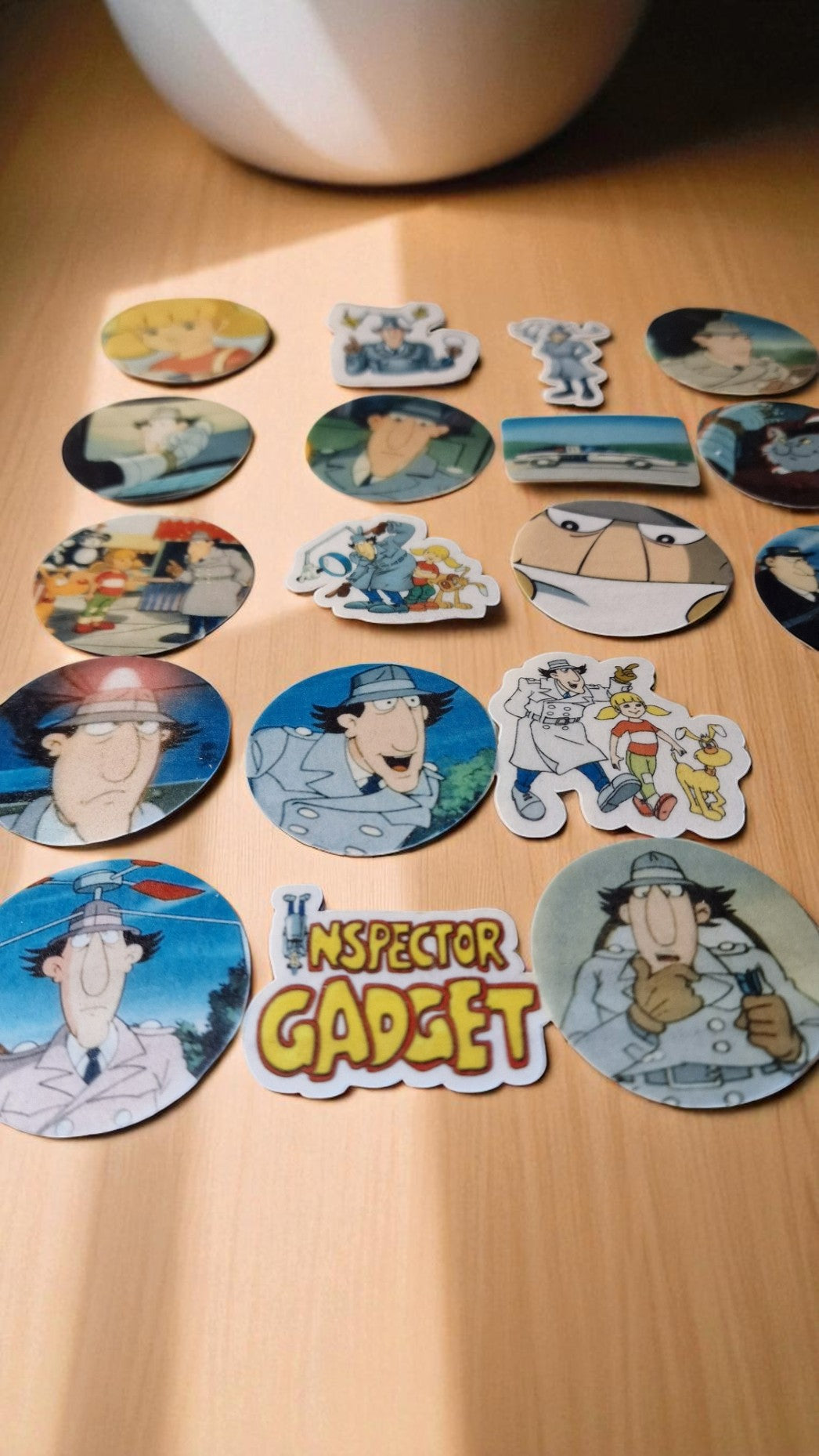 Collection of Inspector Gadget stickers on a wooden surface