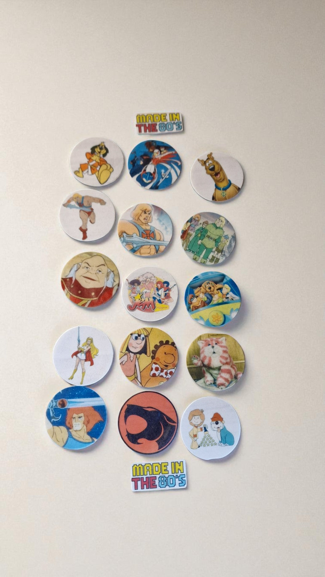 Collection of colorful buttons with cartoon characters on a beige background