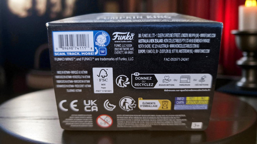 Back of a Funko product box with various logos and text on a reflective surface.