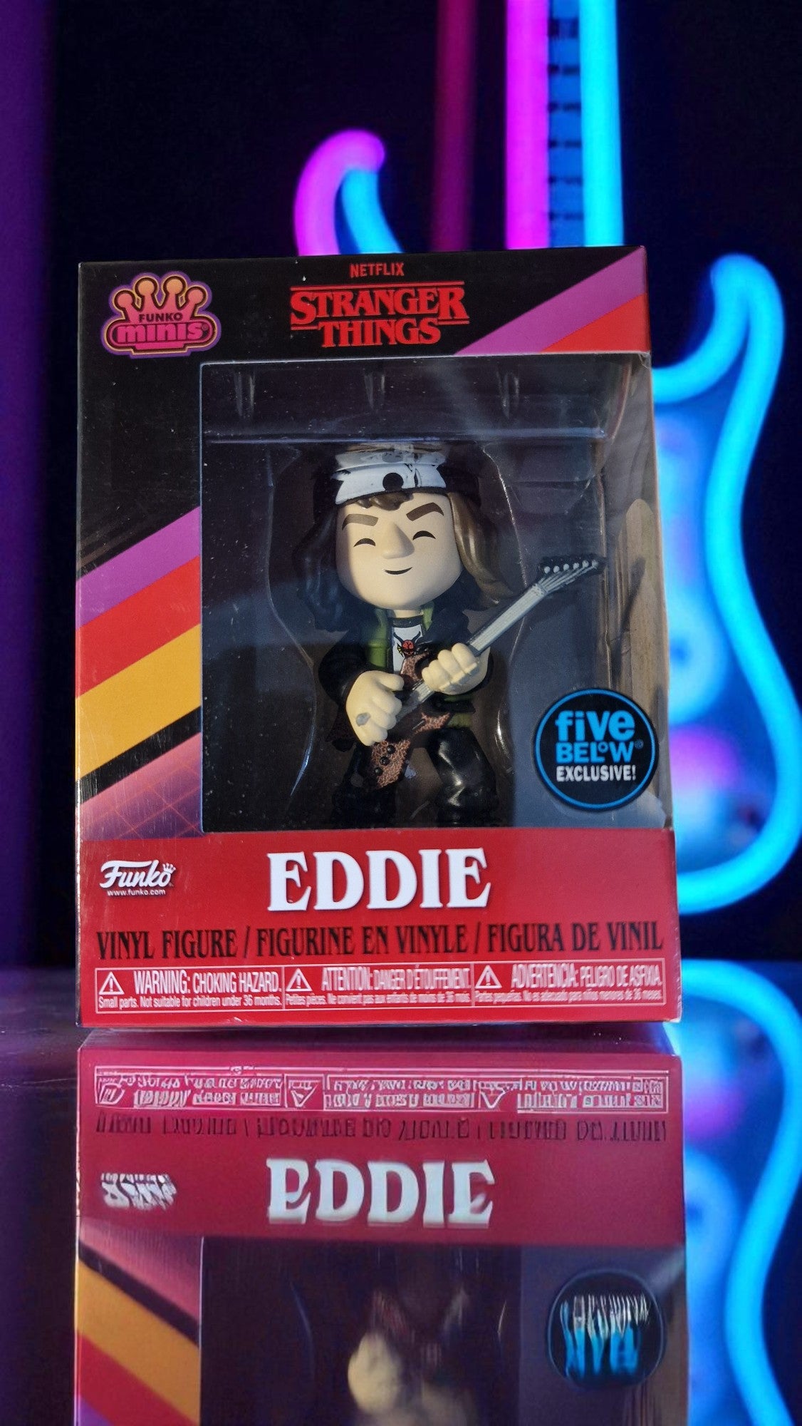 Stranger Things Eddie action figure packaging with neon lights in the background
