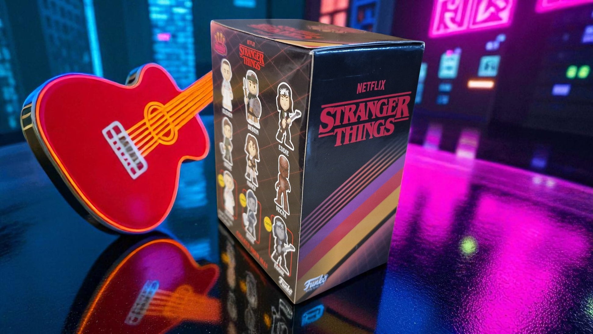 Netflix Stranger Things box with a red guitar-shaped object on a reflective surface.