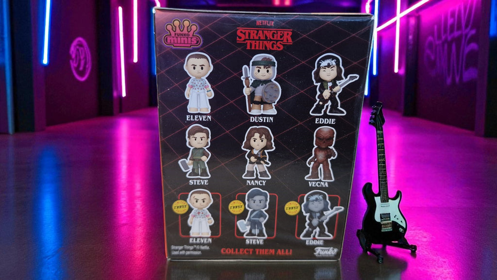 Box of 'Stranger Things' figurines with a guitar on a neon-lit background