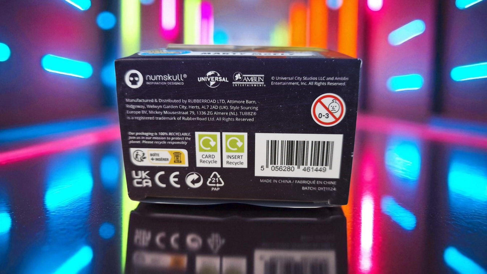 Computer hardware box with visible branding and certification logos against a colorful, blurred background.