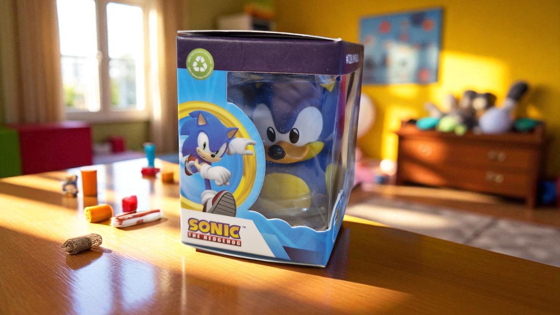 Sonic the Hedgehog toy packaging on a table with a child playing in the background