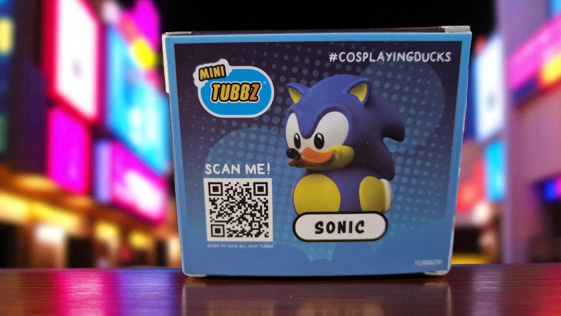 Sonic figurine packaging with QR code on a colorful background
