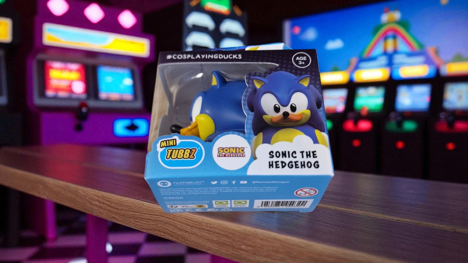 Sonic the Hedgehog toy packaging on a table with arcade machines in the background