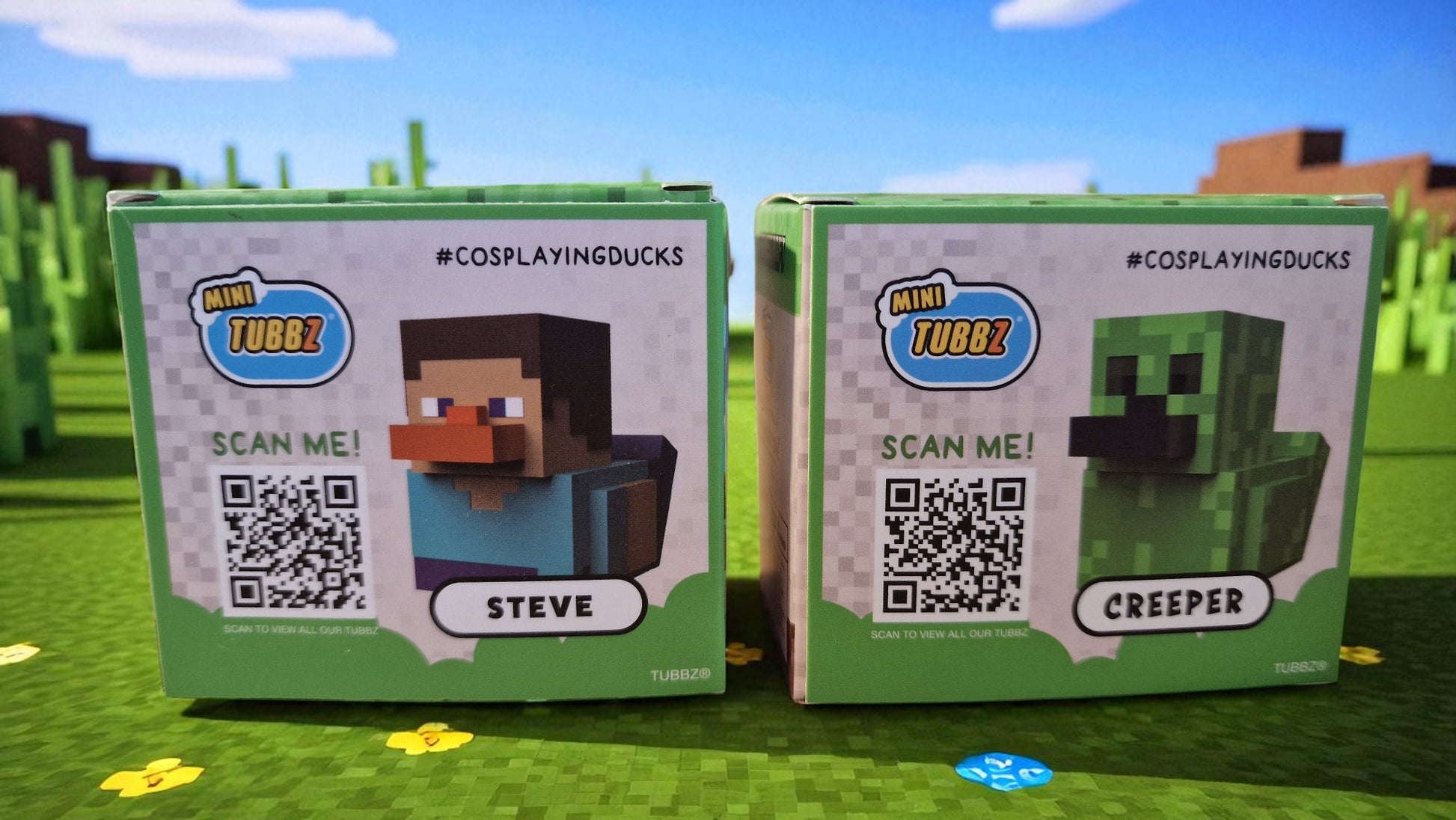 Two toy boxes labeled 'Steve' and 'Creeper' with QR codes on a grassy background.