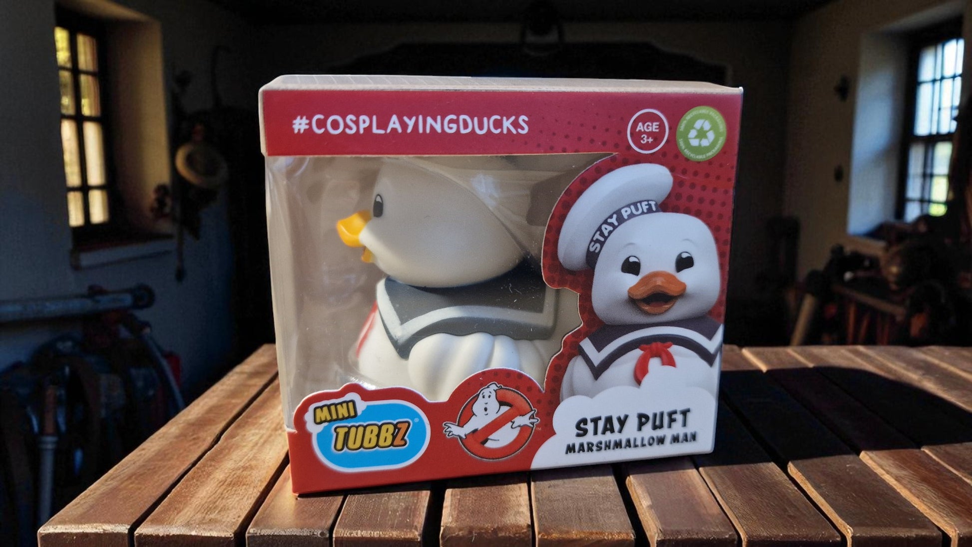 Stay Puft Marshmallow Man figurine packaging on a wooden table