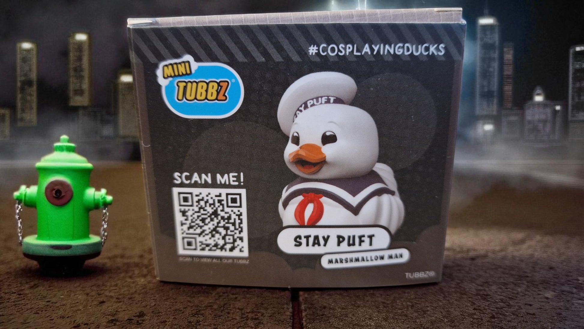 Stay Puft Marshmallow Man toy with packaging featuring a QR code and 'CosplayingDucks' branding.