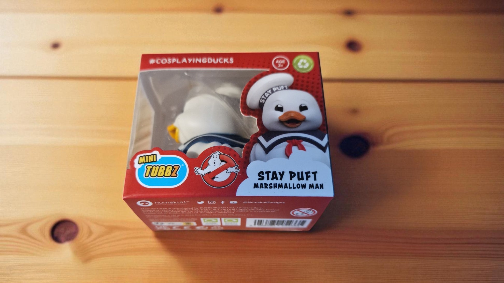 Stay Puft Marshmallow Man toy figure in packaging on a wooden surface