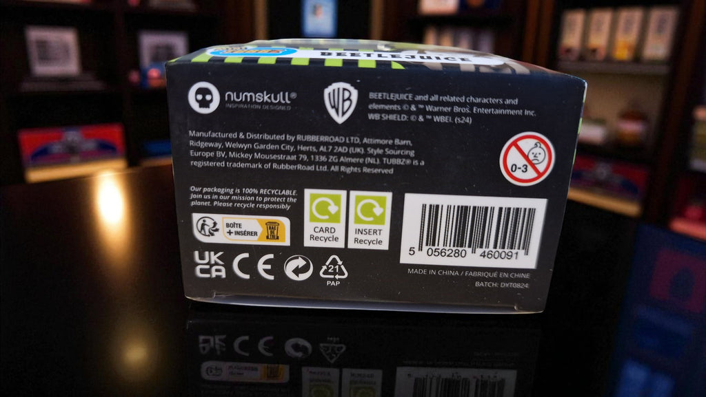 Back view of a Numskull product packaging with branding and recycling symbols.
