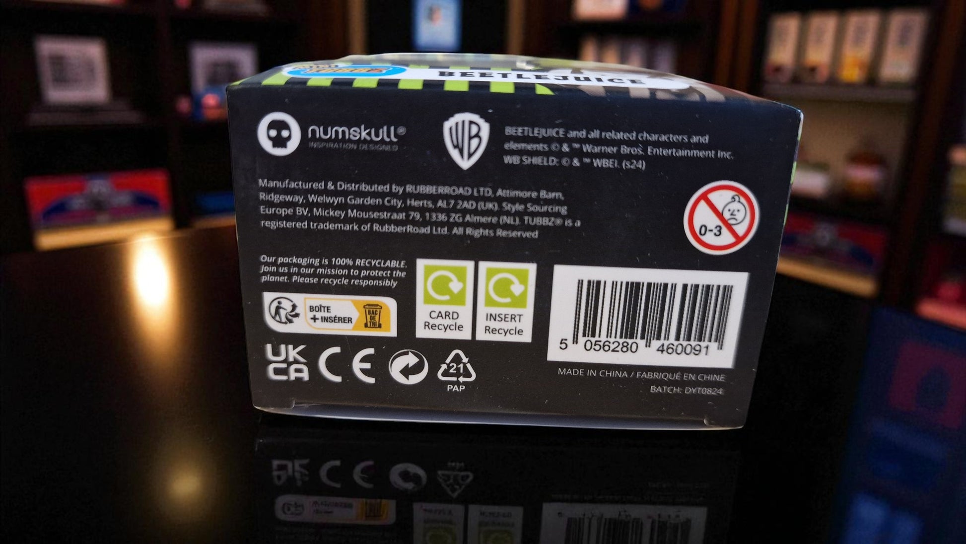 Back view of a Numskull product packaging with branding and recycling symbols.