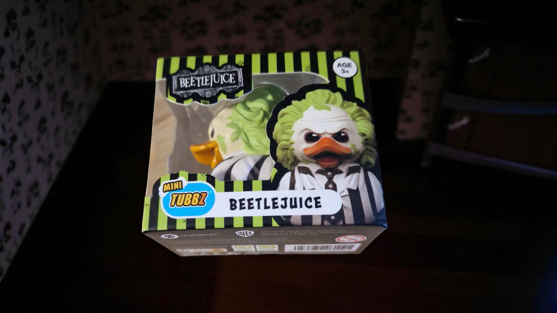 Boxed toy figure of a character from 'Beetlejuice' on a dark background