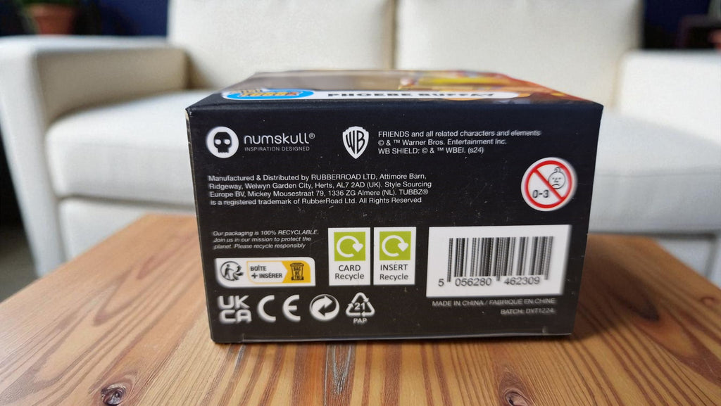Black box with branding and product details on a wooden surface