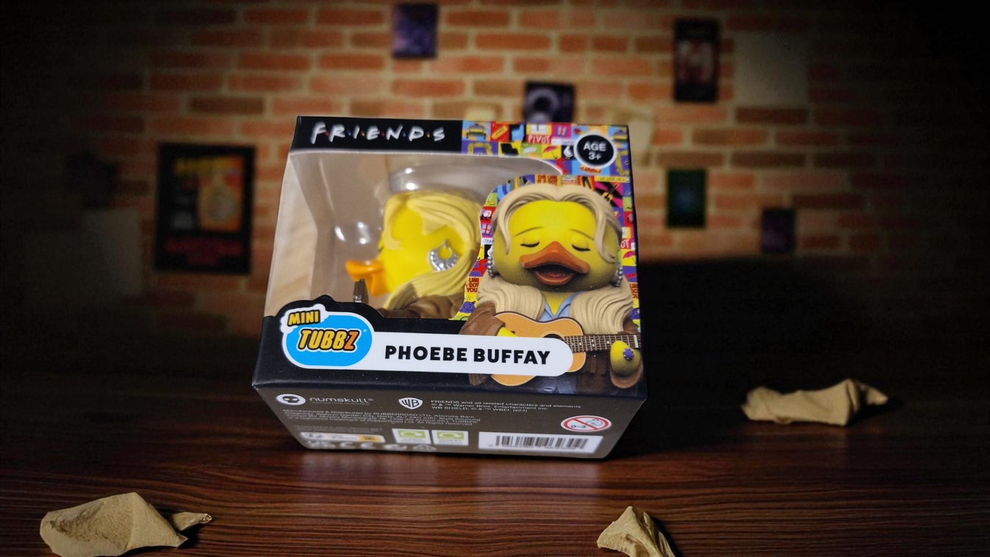 Funko Pop! vinyl figure in packaging with 'Friends' branding on a wooden surface.