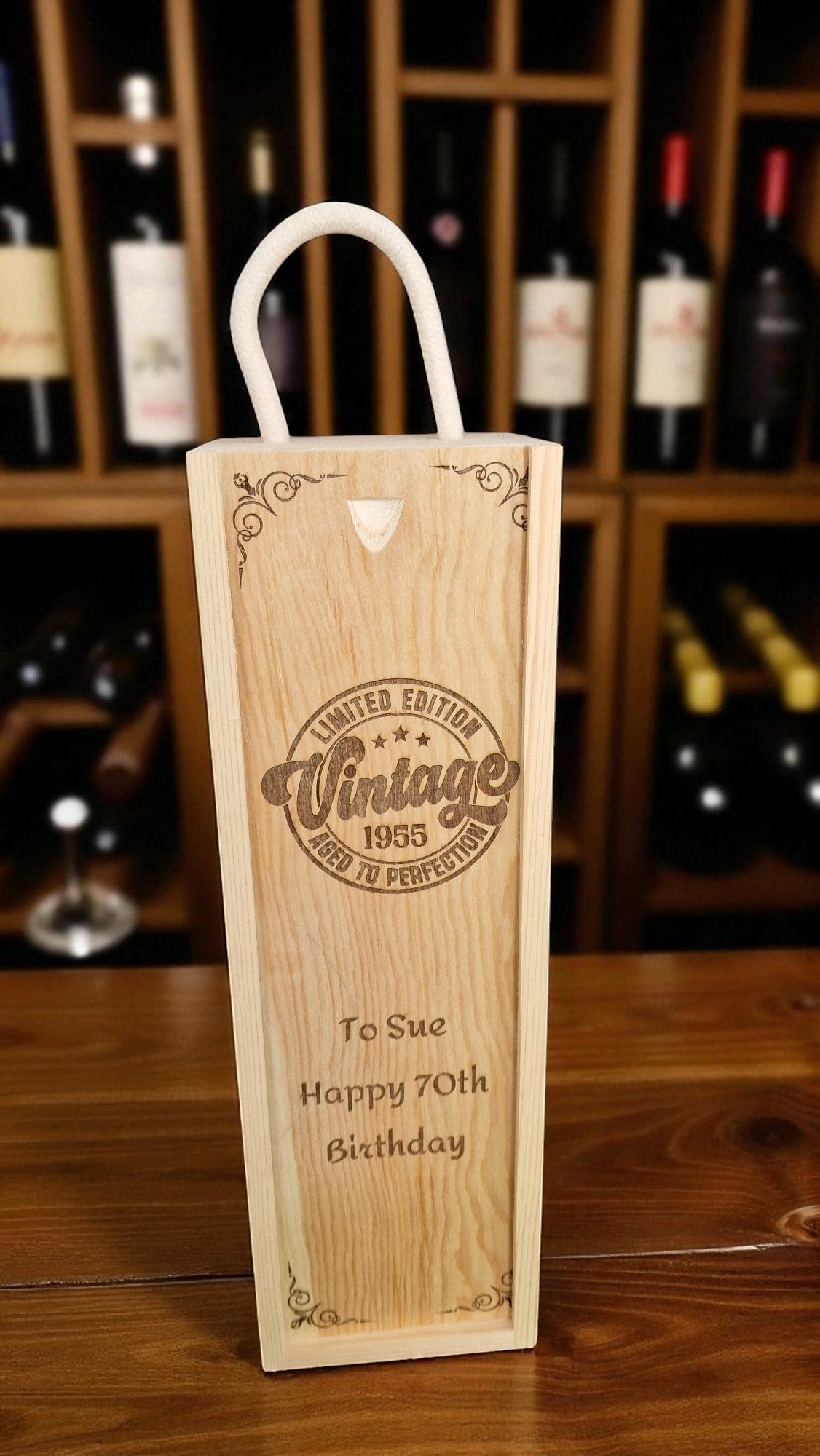 Wooden wine box with engraved text in a wine cellar setting