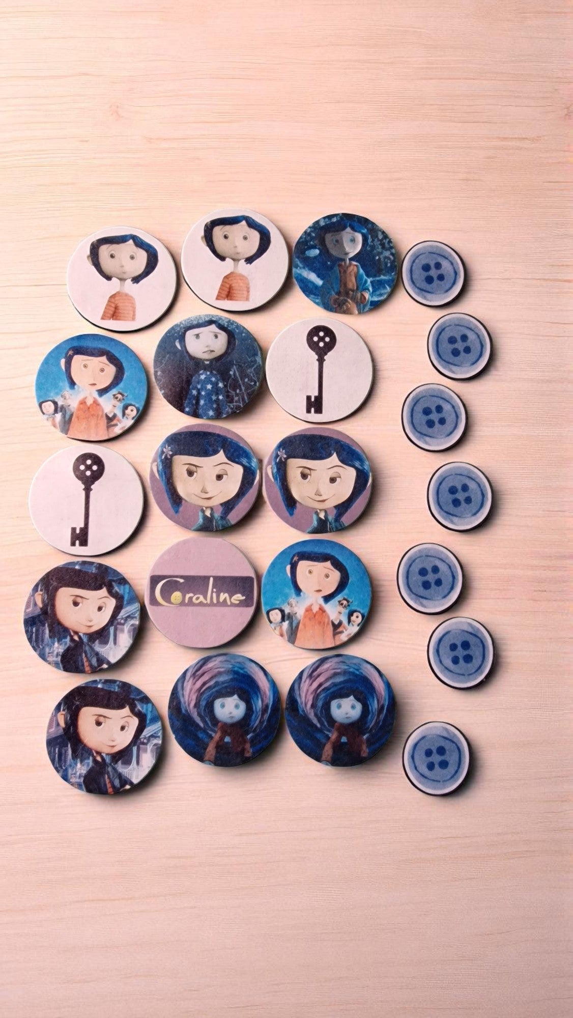 Collection of buttons with cartoon character designs on a wooden surface