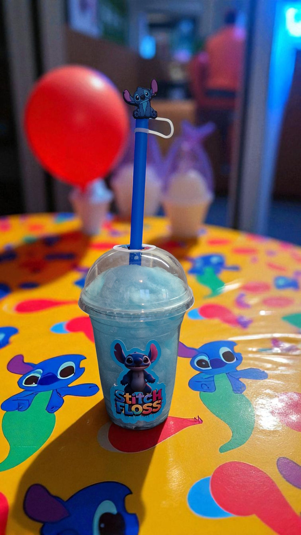 Frozen drink with a straw holder featuring a character on a colorful table.