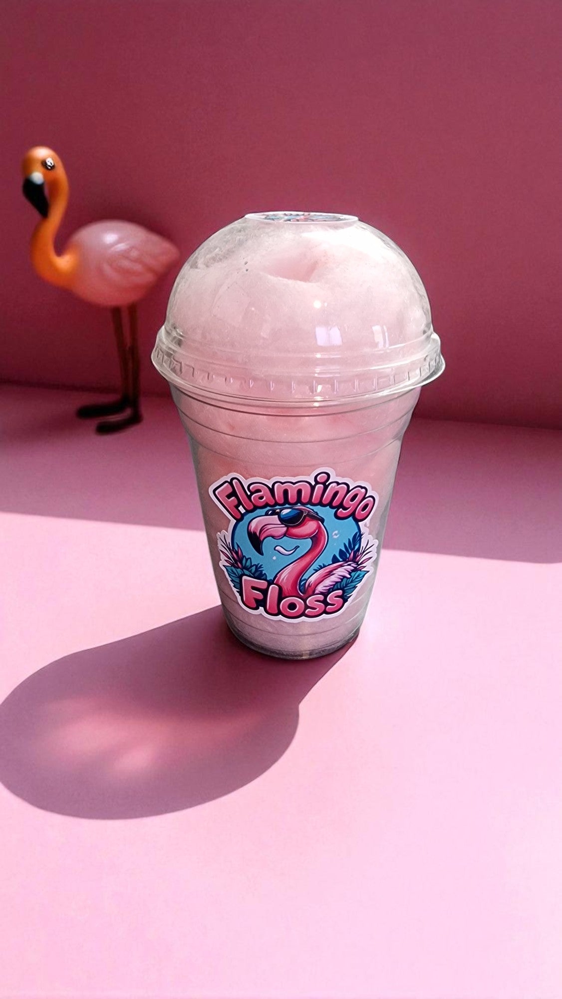 Pink slushy in a cup with 'Flamingo Floss' branding on a pink background
