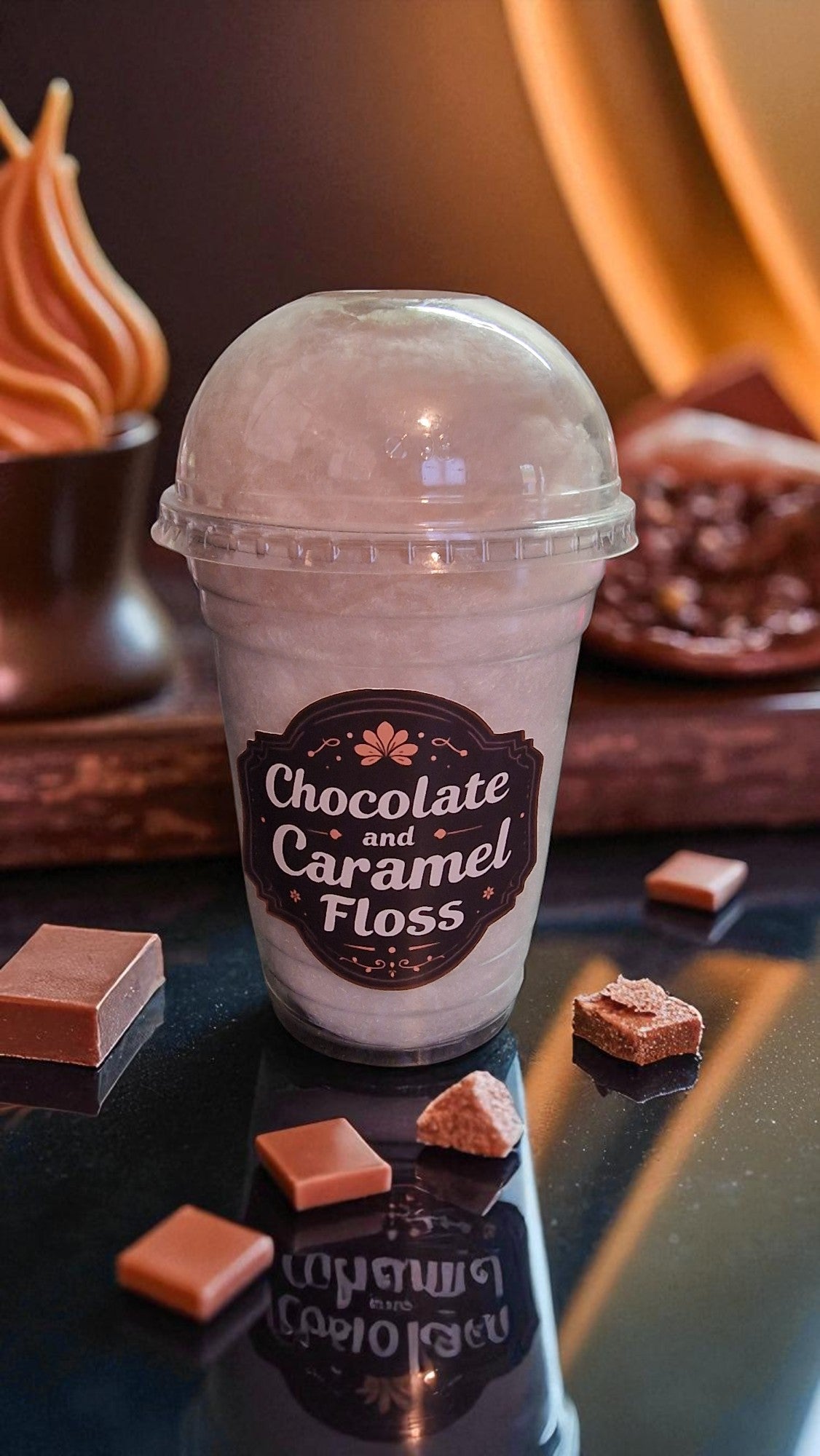 Ice cream cup labeled 'Chocolate and Caramel Floss' with fudge and chocolate pieces on a reflective surface.