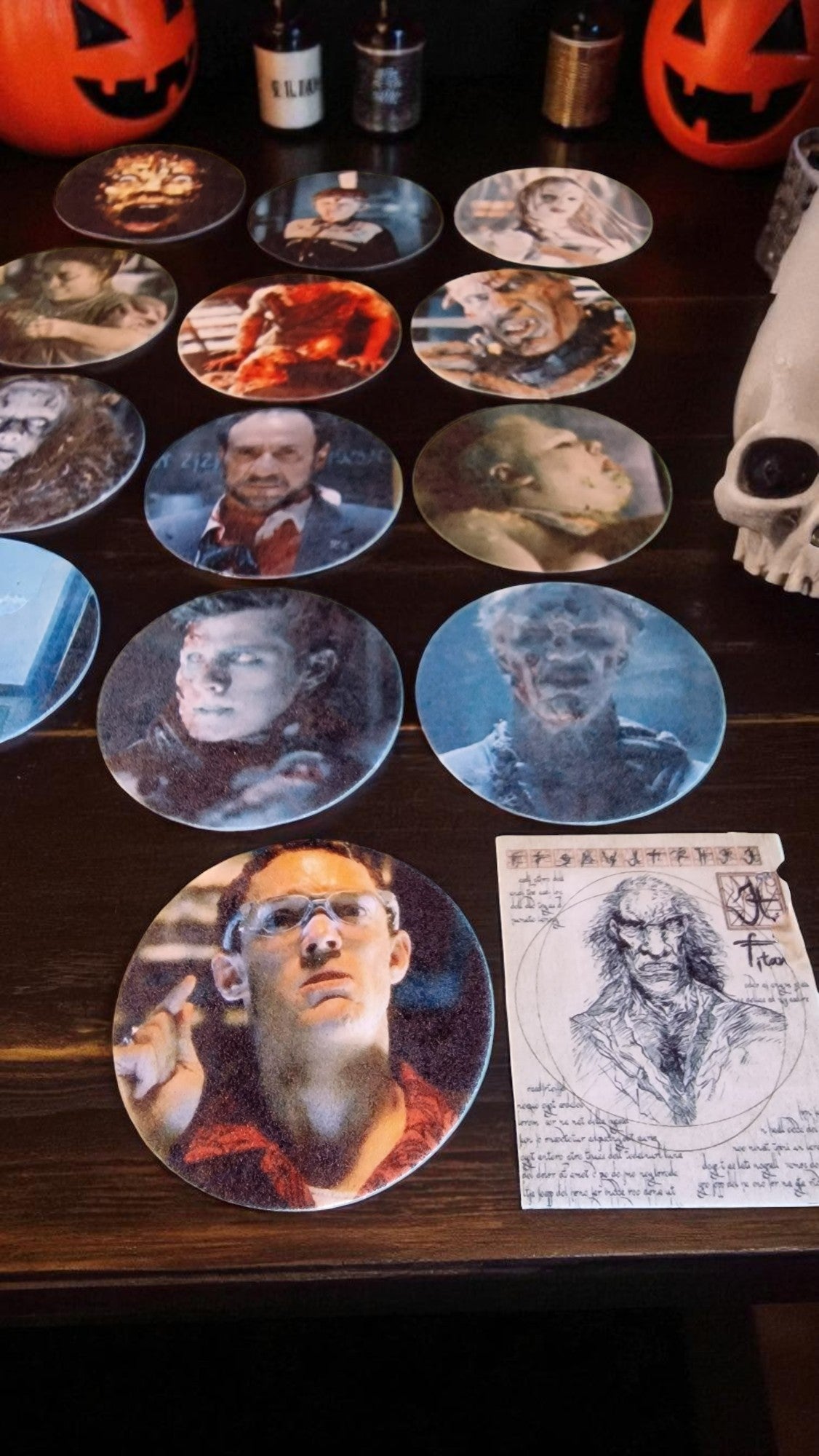 Collection of circular portraits on a dark surface with Halloween decorations.