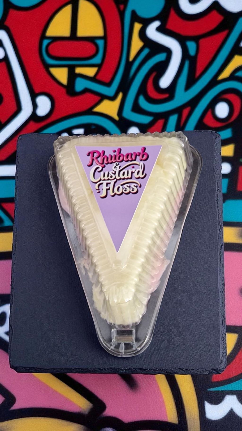 Ice cream cone with 'Rhubarb Custard Floss' label on a colorful background