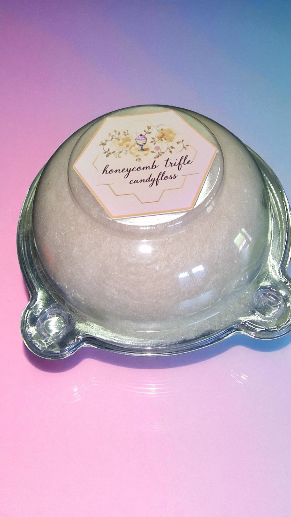 Candy dish with a honeycomb trifle candyfloss product on a gradient pink and blue background