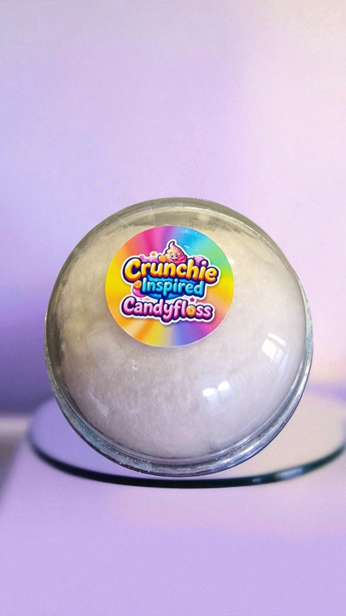 Round candy floss product with a colorful label on a purple background