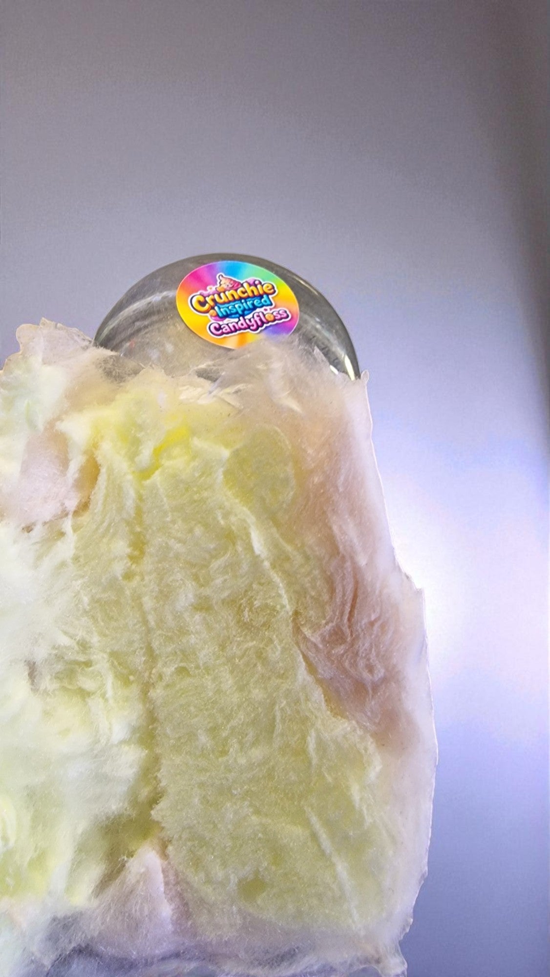 Close-up of a yellow substance with a colorful label on top, against a neutral background.