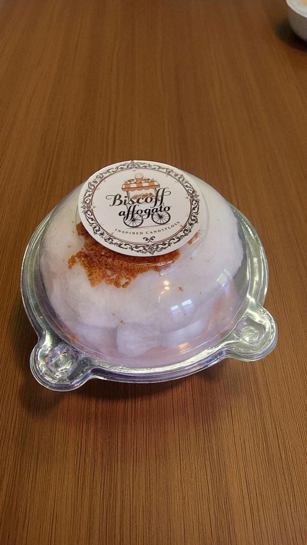 Biscotti cookie in a clear plastic container on a wooden surface