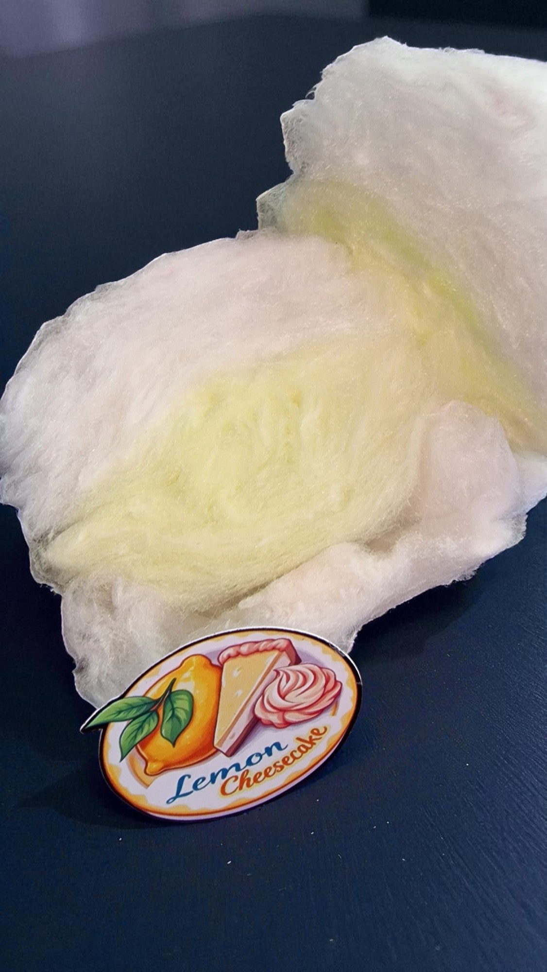 Lemon cheesecake flavor label on a piece of cotton candy