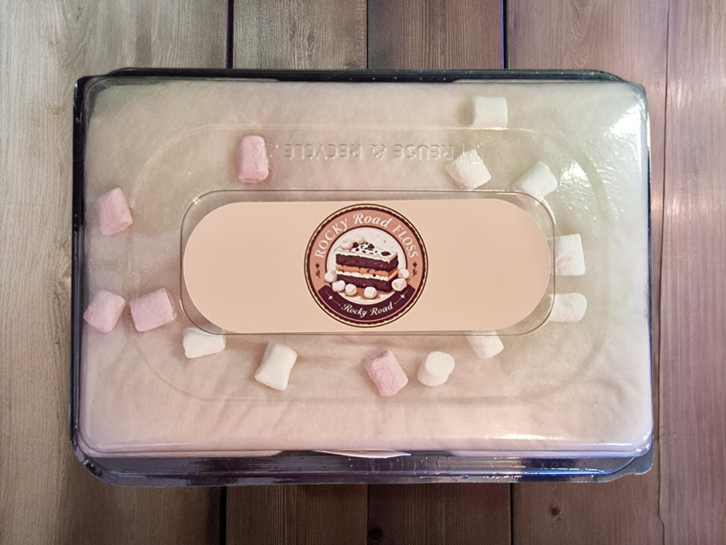 Pink makeup compact with a visible brand logo on a wooden surface