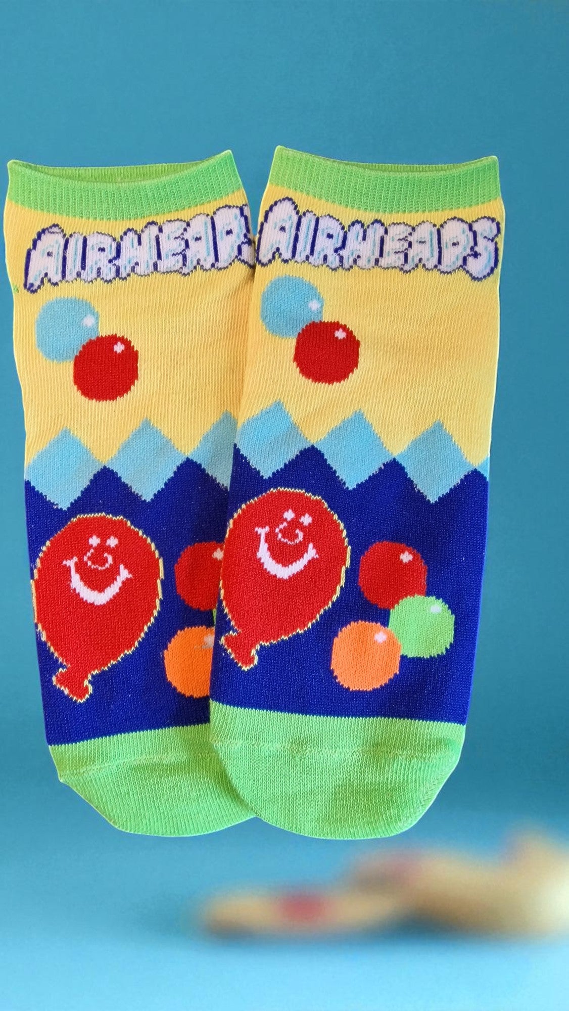 Colorful children's socks with cartoon balloons on a blue background