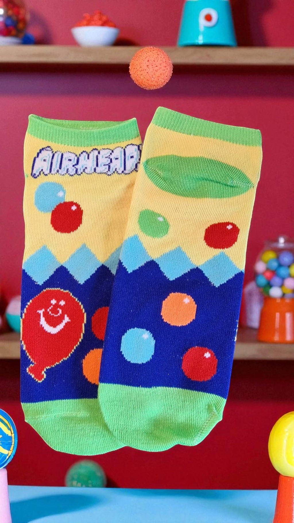 Colorful socks with cartoon design on a red background