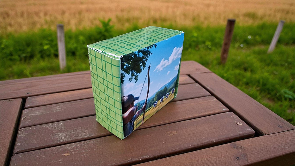 Box with a scenic design on a wooden table outdoors