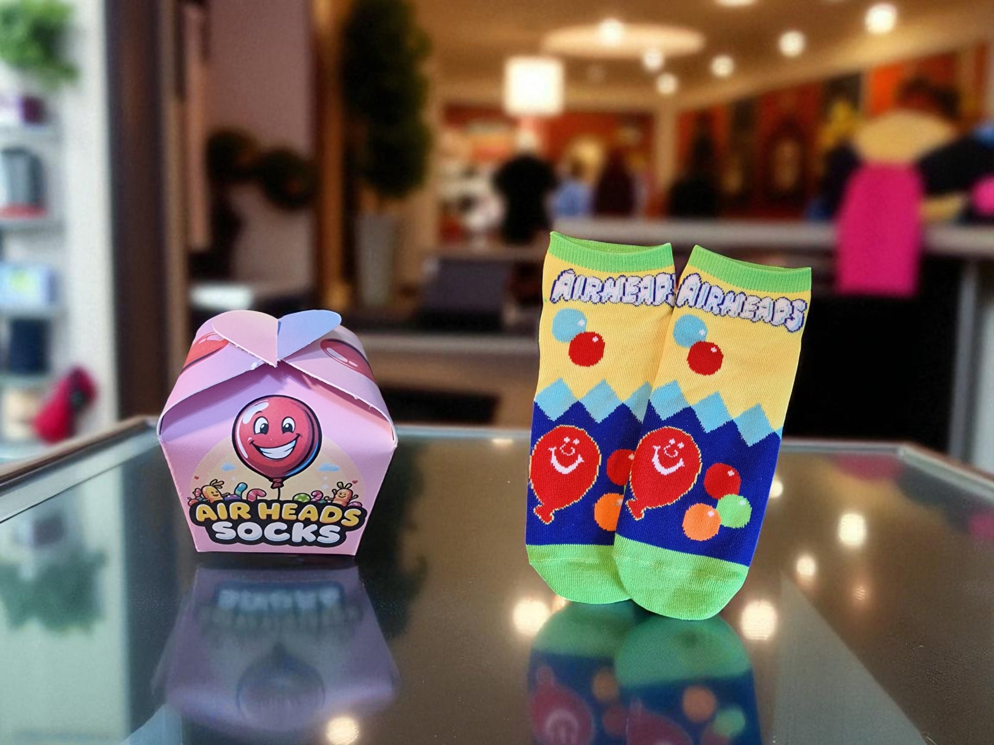 Colorful Air Heads socks with packaging on a reflective surface, blurred indoor background